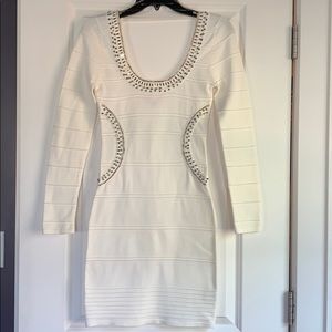 White/cream fitted dress with embellishments.